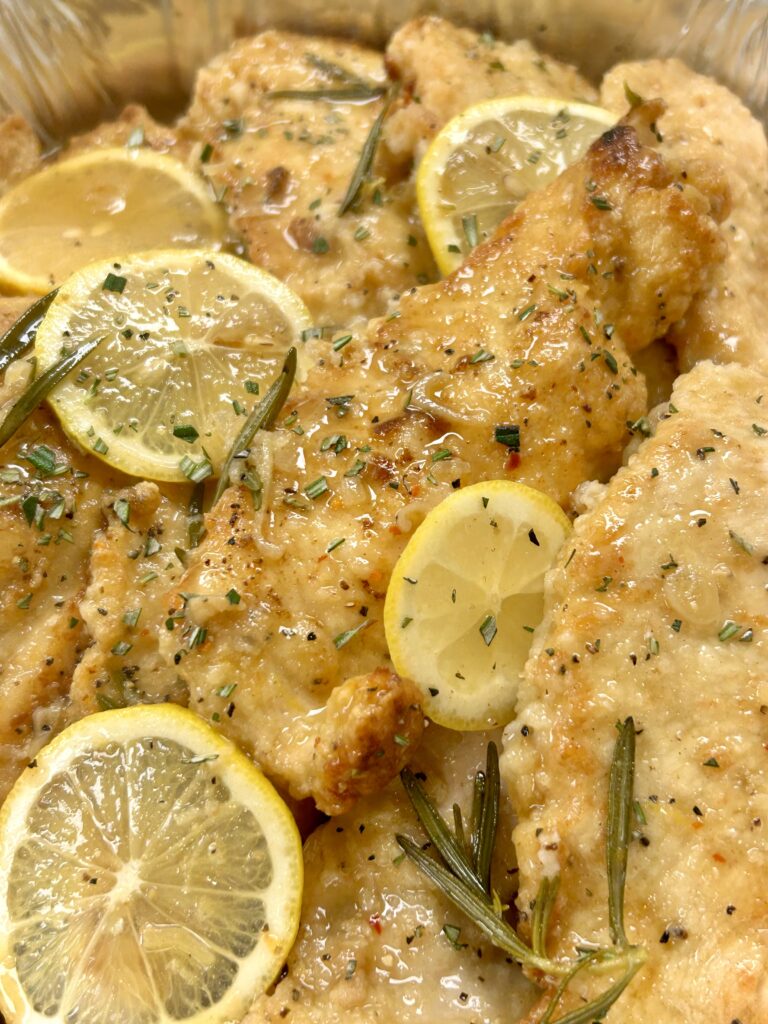 Lemon rosemary chicken with white wine sauce, a scratch-made catering entrée from Happy Belly Chefs